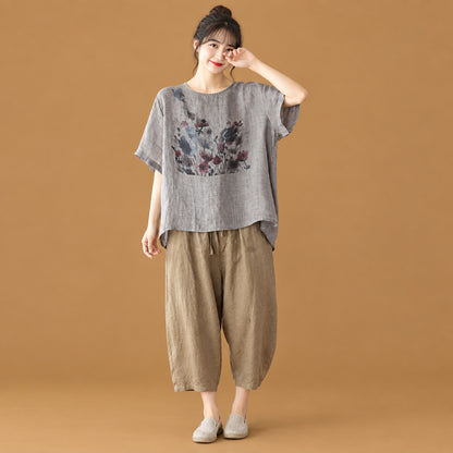 Alternative aesthetic women's short-sleeve top featuring an artistic ink wash print and an asymmetric cut for a distinct silhouette
